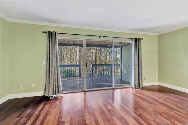 a view of a big room with wooden floor and a ceiling fan