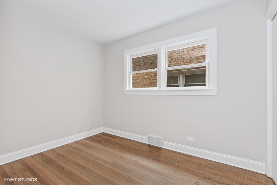 1619 Monroe Street, Unit 1 Evanston, IL 60202 - Photo 9 of 10 an empty room with wooden floor and windows