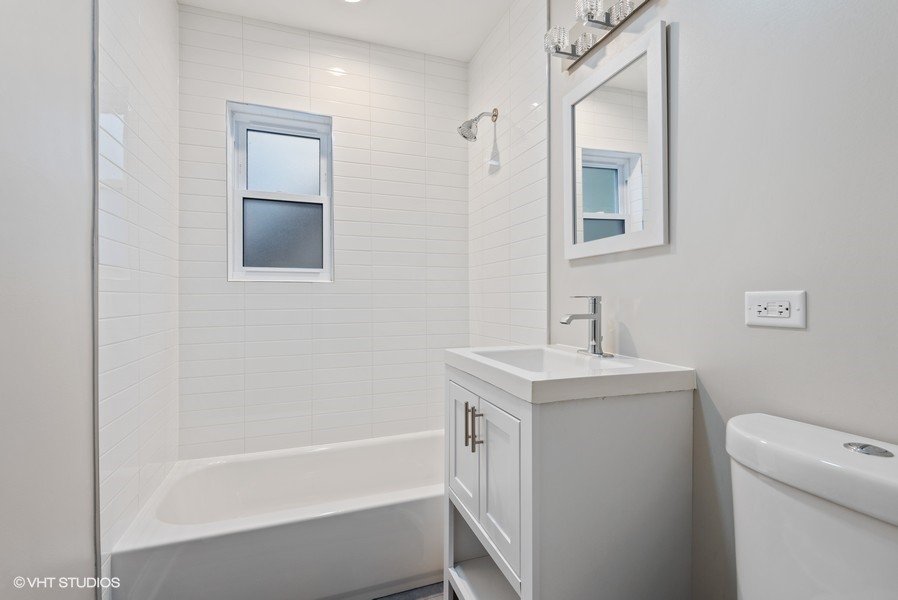 1619 Monroe Street, Unit 1 Evanston, IL 60202 - Photo 10 of 10 a bathroom with a sink a toilet and shower