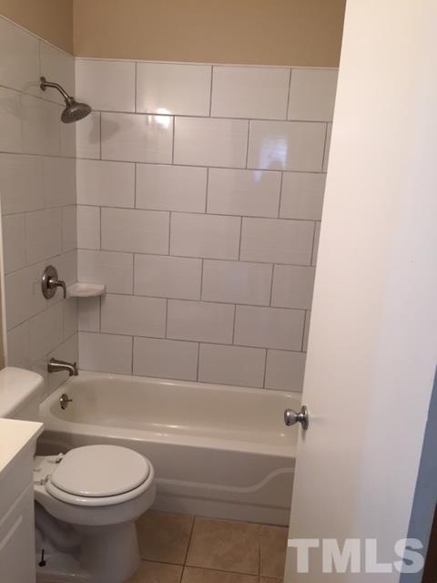 2604 Sanderford Road Raleigh, NC 27610 - Photo 14 of 22 a white bath tub sitting next to a white toilet