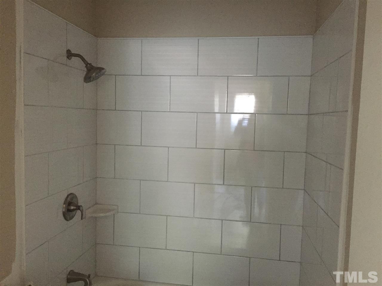 2604 Sanderford Road Raleigh, NC 27610 - Photo 15 of 22 a bathroom with a shower
