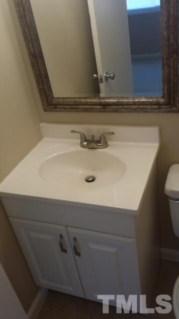 2604 Sanderford Road Raleigh, NC 27610 - Photo 18 of 22 a bathroom with a sink and a toilet
