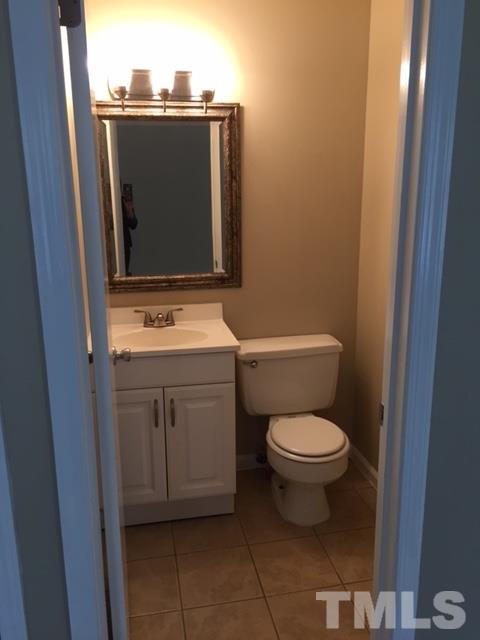 2604 Sanderford Road Raleigh, NC 27610 - Photo 19 of 22 a bathroom with a toilet and a sink