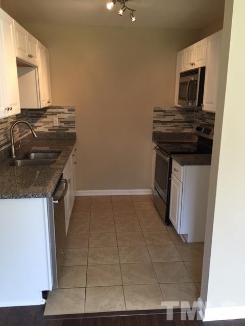 2604 Sanderford Road Raleigh, NC 27610 - Photo 7 of 22 a kitchen with a stove and a microwave