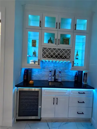 a kitchen with granite countertop a refrigerator and a stove top oven