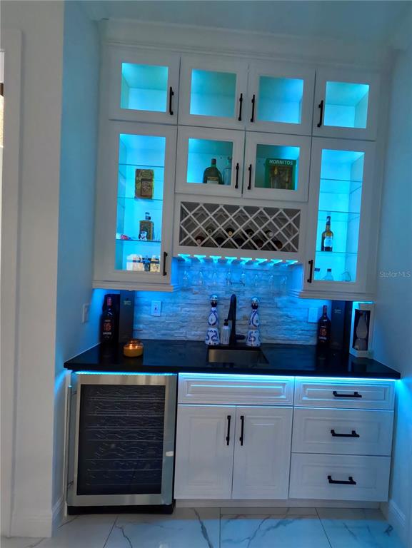 10112 Judy Road Dover, FL 33527 - Photo 11 of 49 a kitchen with white cabinets and a fireplace