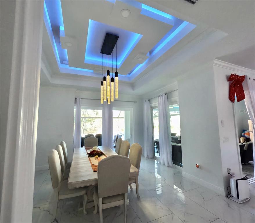10112 Judy Road Dover, FL 33527 - Photo 14 of 49 a view of a dining room with furniture and chandelier