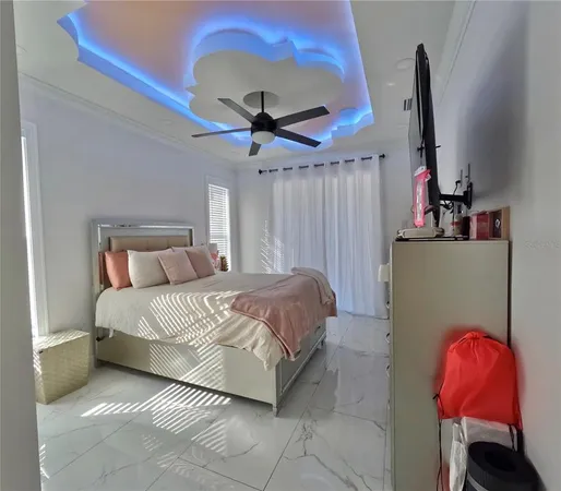 a bedroom with a bed and a chandelier