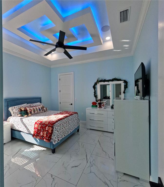 10112 Judy Road Dover, FL 33527 - Photo 22 of 49 a bedroom with a bed and a chandelier