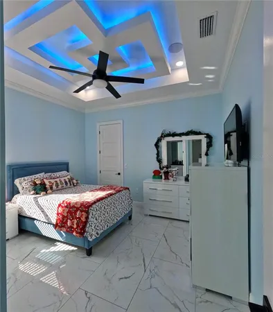 a bedroom with a bed couch and ceiling fan