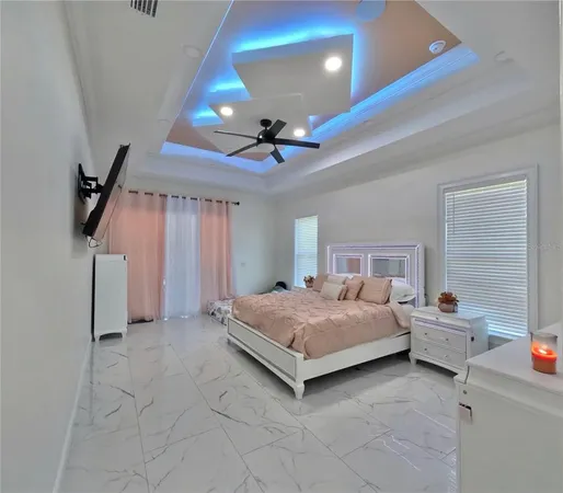 a large bedroom with a large window and furniture