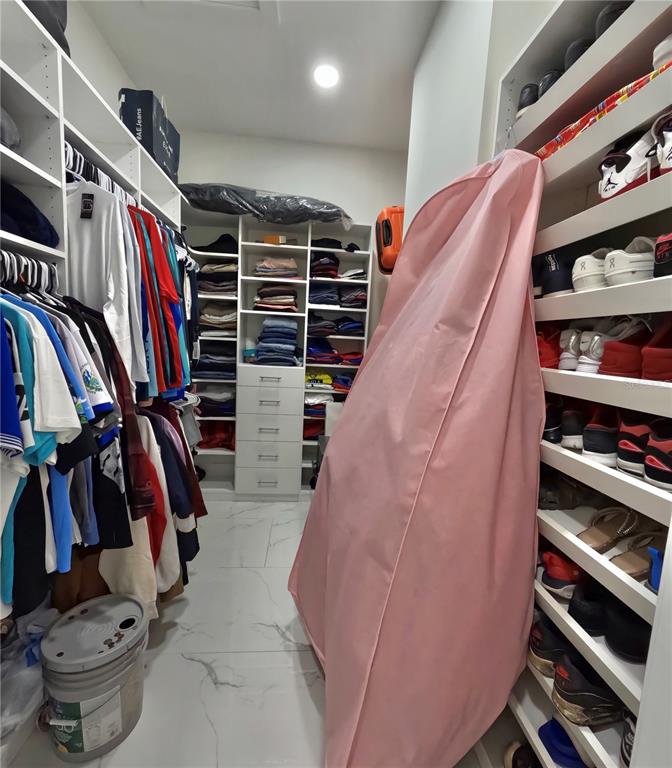 10112 Judy Road Dover, FL 33527 - Photo 31 of 49 a view of walk in closet with clothes and shoes
