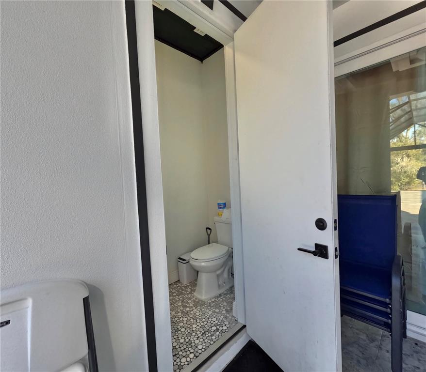 10112 Judy Road Dover, FL 33527 - Photo 49 of 50 a bathroom with a granite countertop toilet and a shower