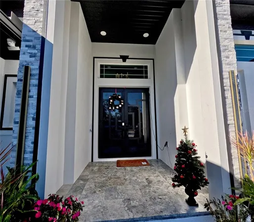 a room with painting on the wall and a potted plant