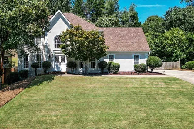 a front view of a house with a yard