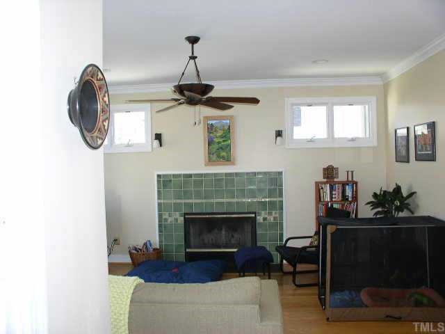 217 Stable Road Carrboro, NC 27510 - Photo 6 of 10 Living room with hardwood floors, fireplace with beautifully detailed tile surround.