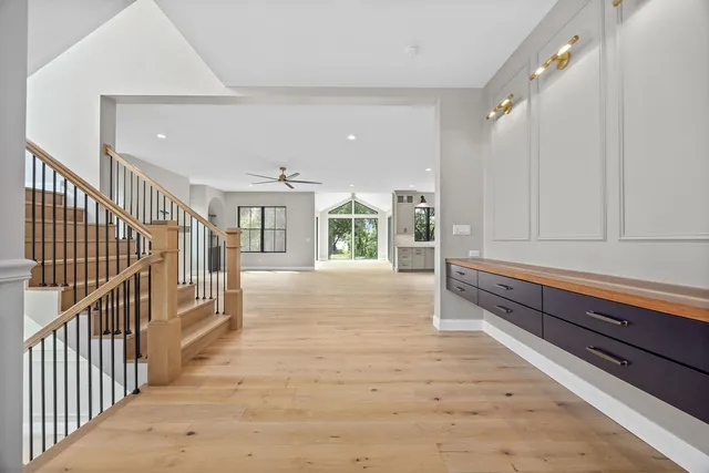 a view of hallway with cabinets and wooden floor
