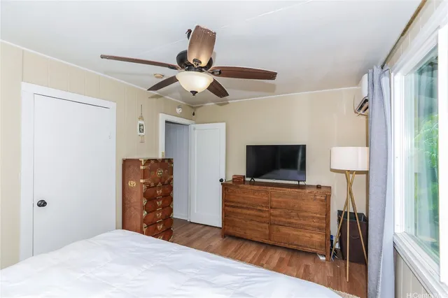 a bedroom with a bed and a flat screen tv