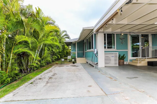 a view of a house with a small yard and plants