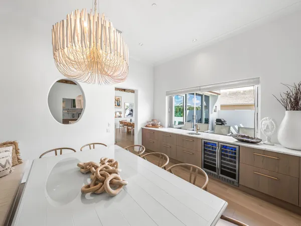a view of a dining room with furniture a chandelier and wooden floor