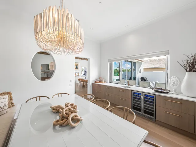 a view of a dining room with furniture a chandelier and wooden floor