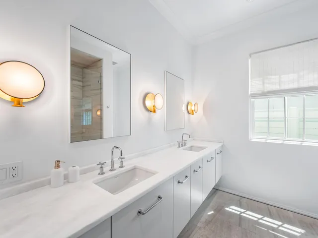 a bedroom with a bed a window and a chandelier