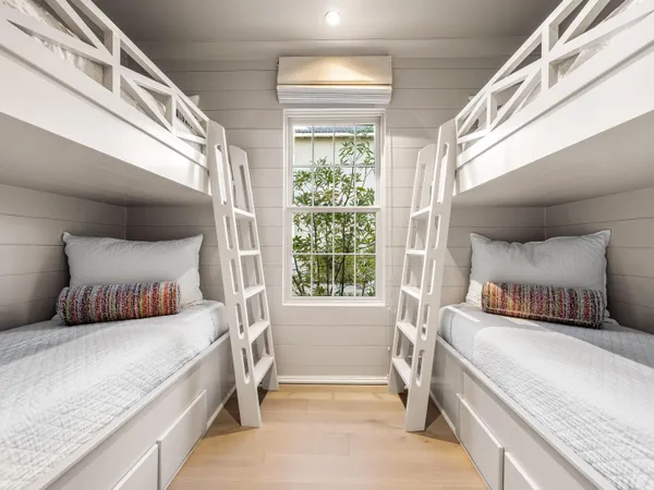 a bedroom with a large bed and a window