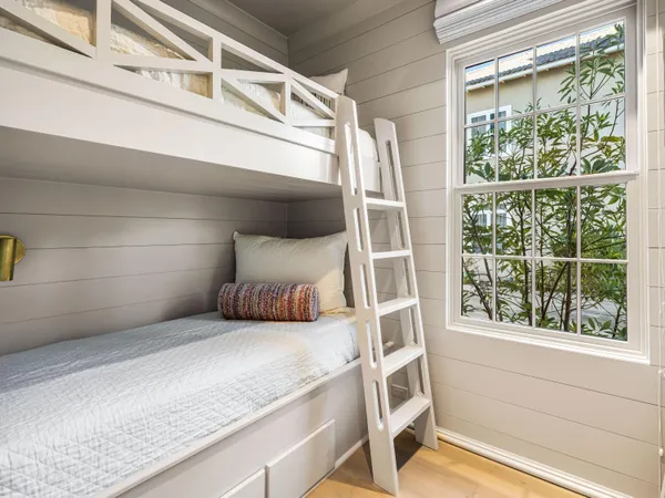 a bedroom with a large bed and a window