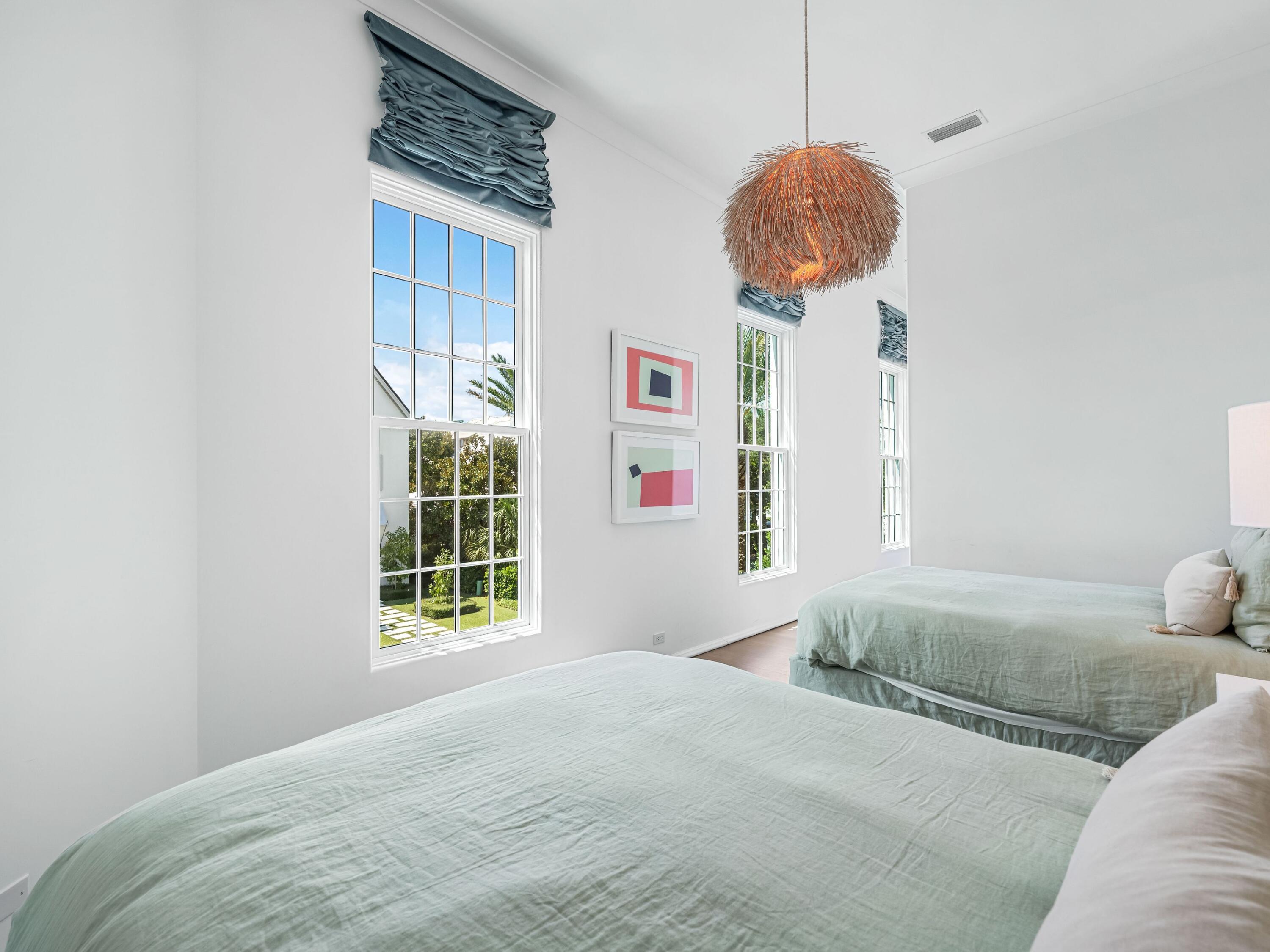 41 Elysee Ct Inlet Beach Inlet Beach, FL 32461 - Photo 39 of 68 a bedroom with a bed a window and a chandelier