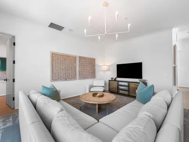 a view of a white house with a yard and plants