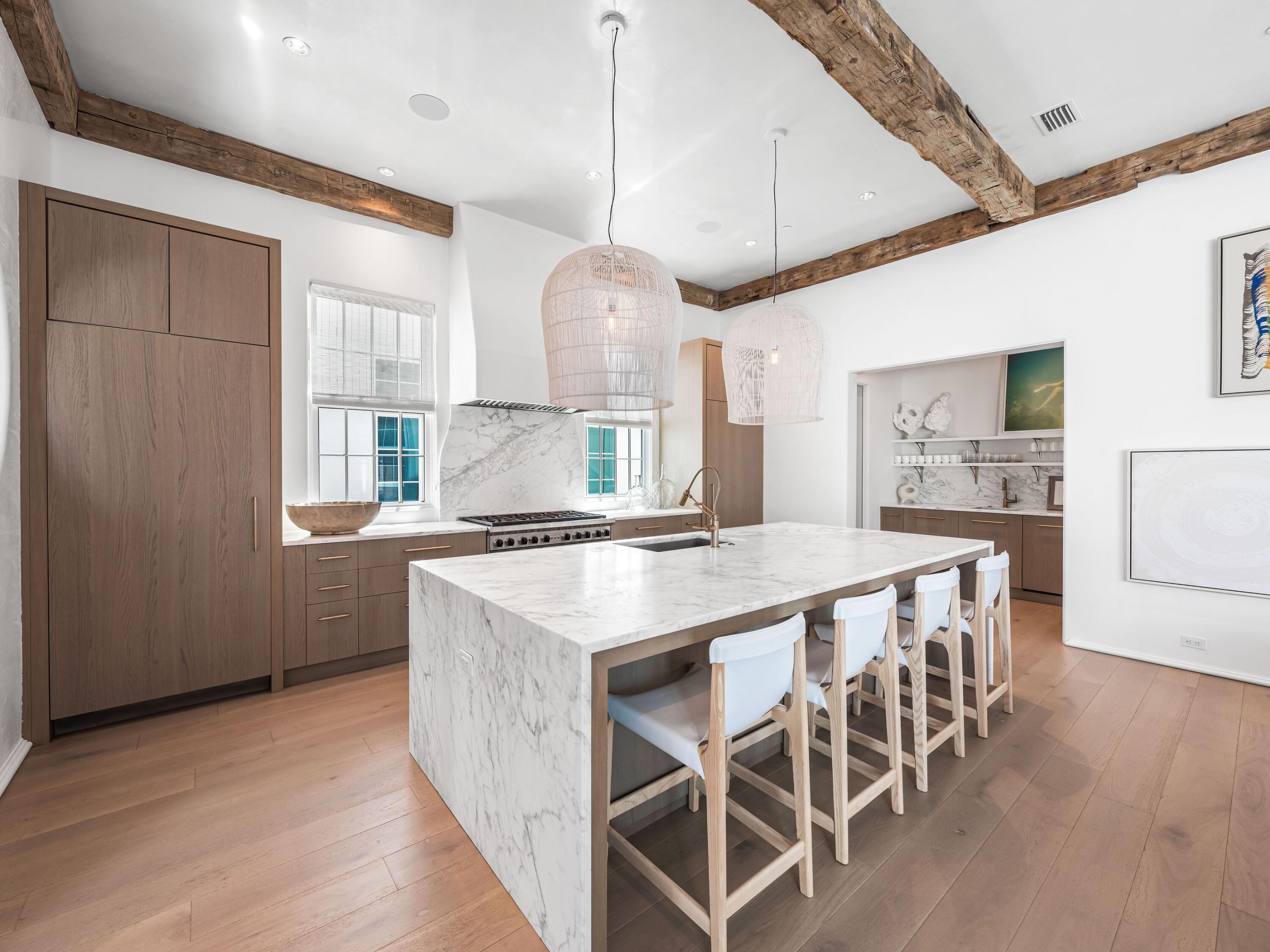 41 Elysee Ct Inlet Beach Inlet Beach, FL 32461 - Photo 9 of 68 a kitchen with stainless steel appliances granite countertop a stove a refrigerator a sink a dining table and chairs with wooden floor