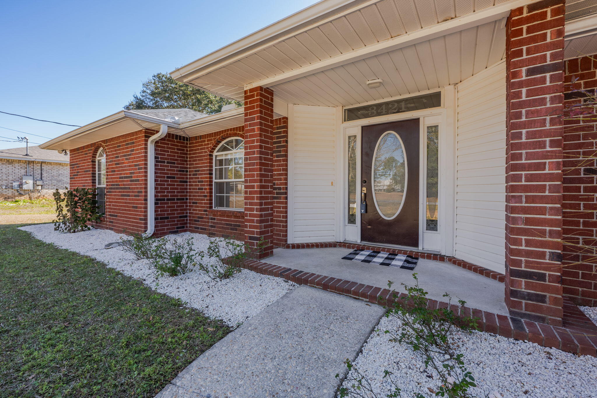 3421 Gardenview Road Pace, FL 32571 - Photo 2 of 26 a front view of a house with garden