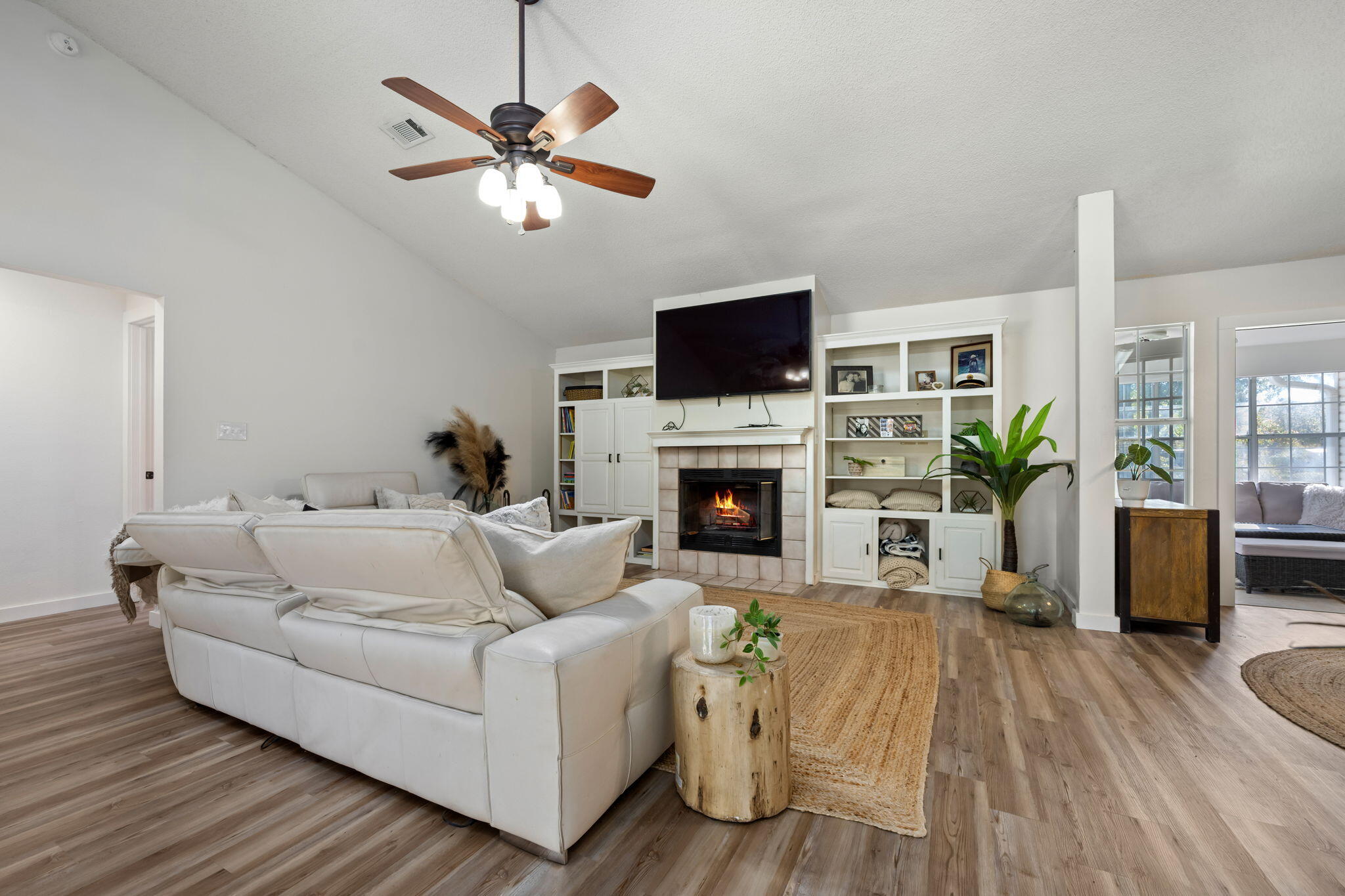 3421 Gardenview Road Pace, FL 32571 - Photo 5 of 26 a living room with furniture a fireplace and a flat screen tv