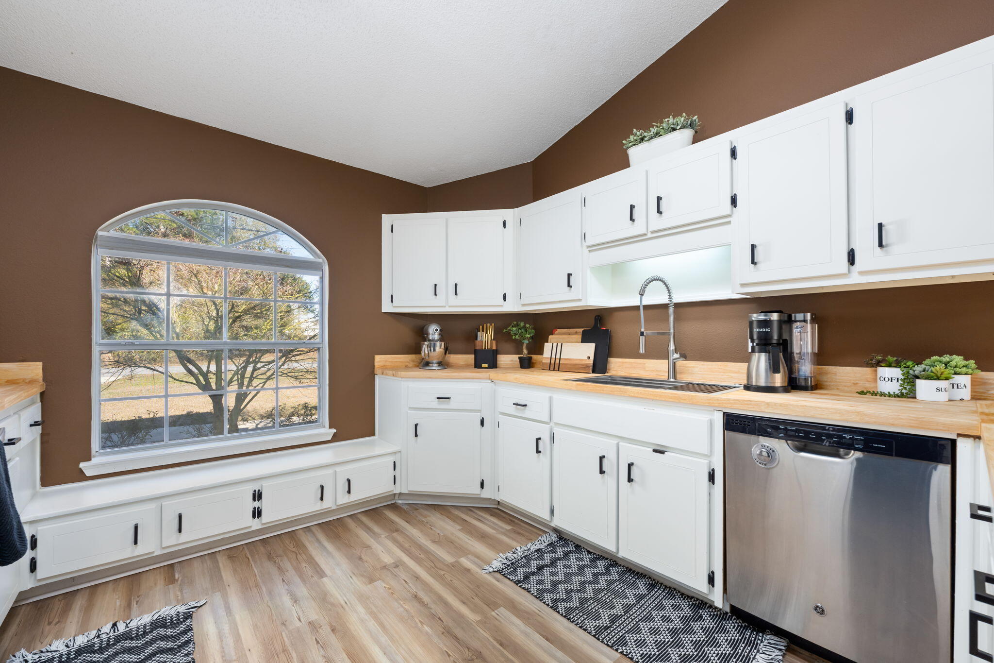 3421 Gardenview Road Pace, FL 32571 - Photo 10 of 26 a kitchen with granite countertop white cabinets and window