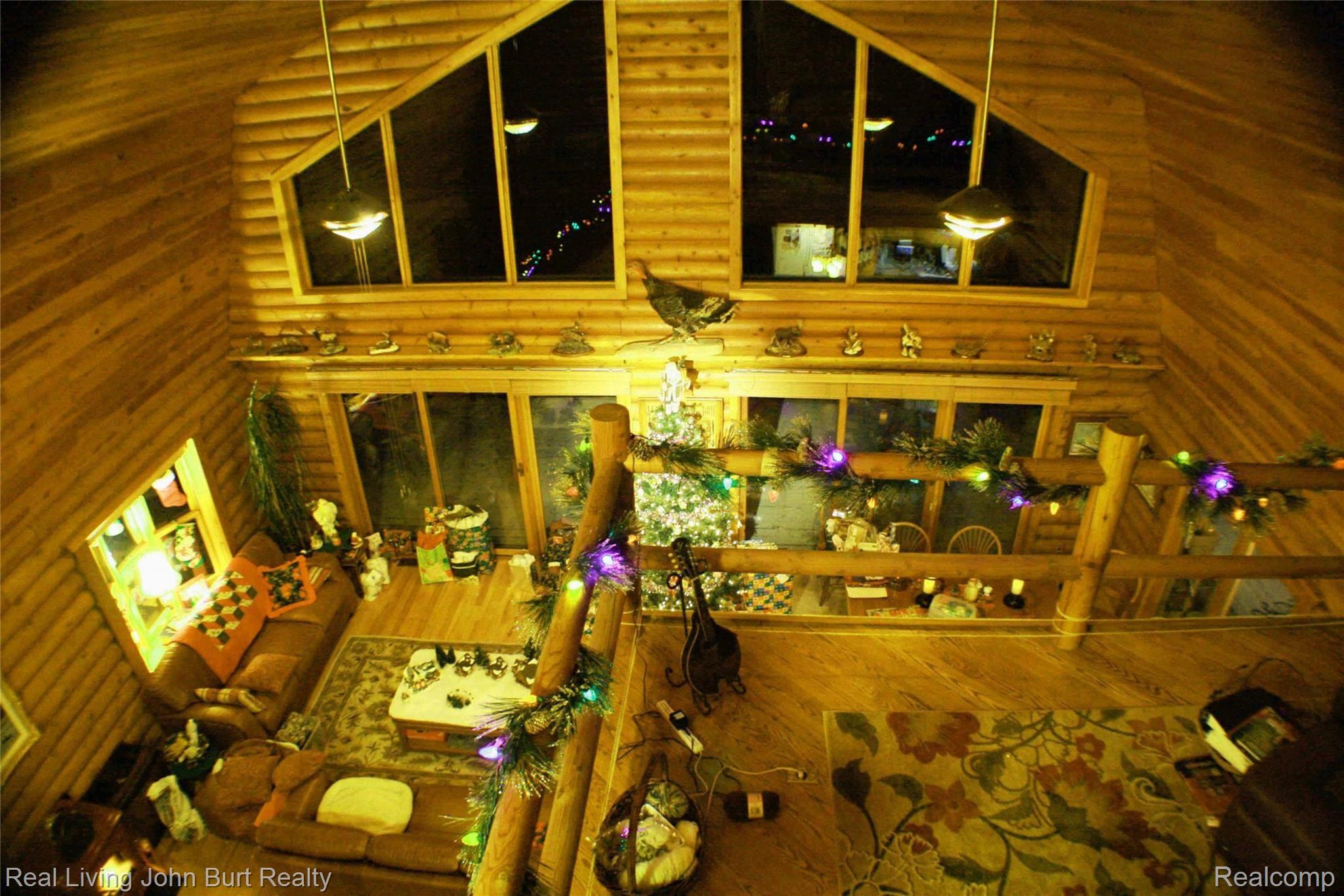 1605 Shoup Road Leonard, MI 48367 - Photo 2 of 37 Great room with vaulted tongue & groove ceiling, six trapezoid windows and 2 nine foot door walls, view from 2nd floor office/sitting area, as seen at Christmas time