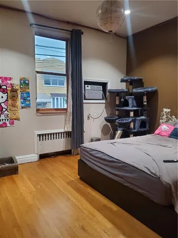 a bedroom with bed and a window
