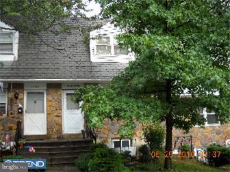 front view of a house with a tree