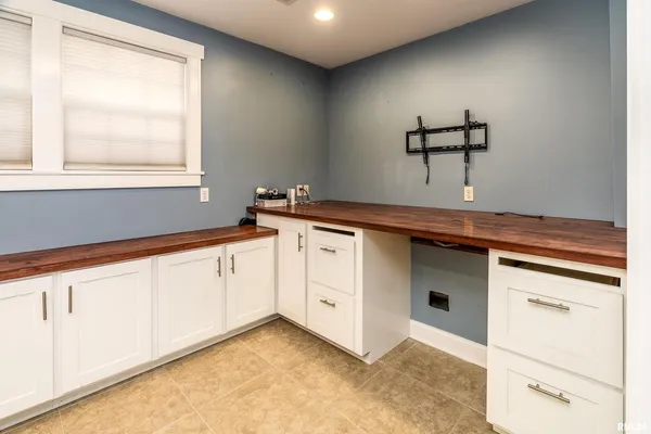 a kitchen with granite countertop white cabinets and white appliances