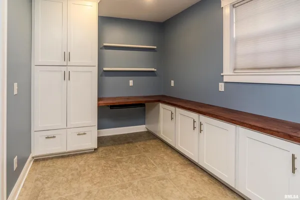 a view of a kitchen with white cabinets