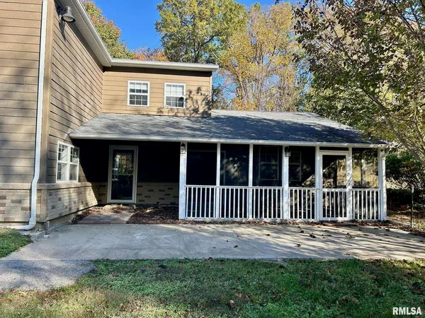 a view of a house with a yard and wooden fence