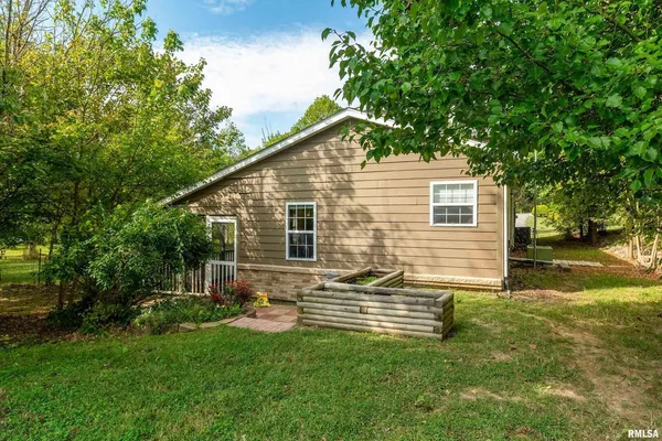 a backyard of a house with table and chairs