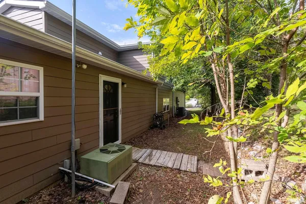 a view of backyard with a table and chair and wooden fence