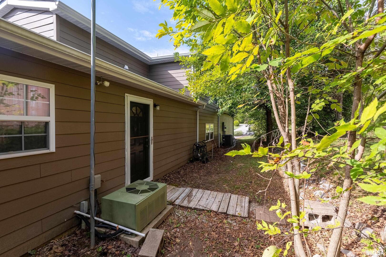 1591 North Reed Station Road Carbondale, IL 62901 - Photo 35 of 44 a view of backyard with a table and chair and wooden fence