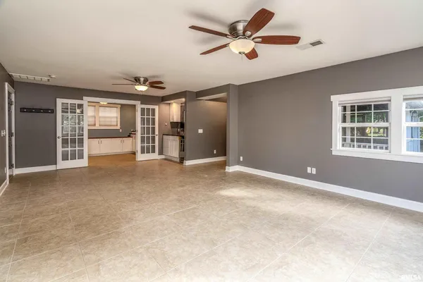 a view of a livingroom with a ceiling fan and window