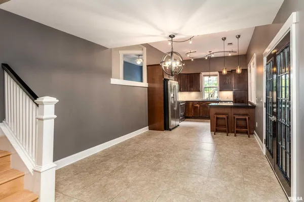 a view of a livingroom with furniture and a kitchen
