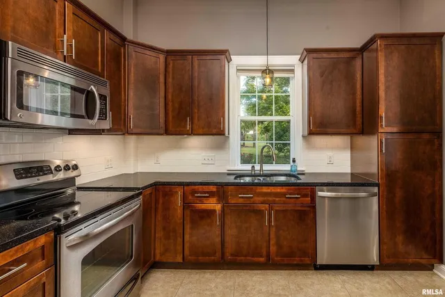 a kitchen with a sink stove and microwave