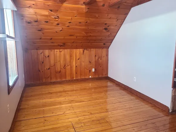 a view of room with window and wooden floor