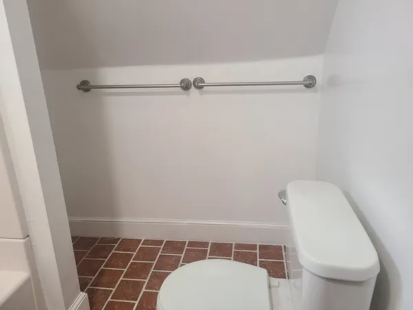 a bathroom with a toilet and a shower