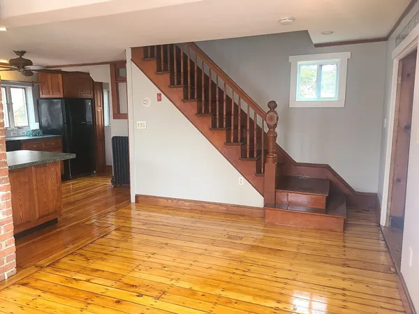 a view of entryway and hall with wooden floor