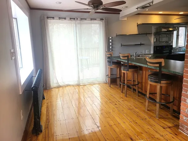 a kitchen with a table chairs and a window